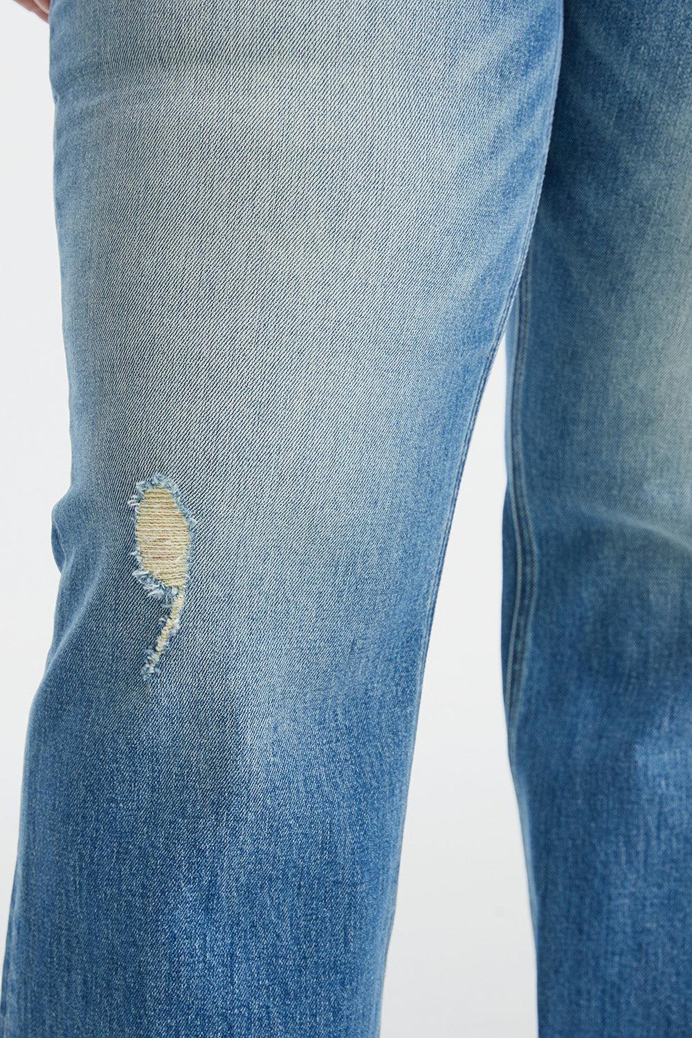 a person wearing a pair of ripped jeans