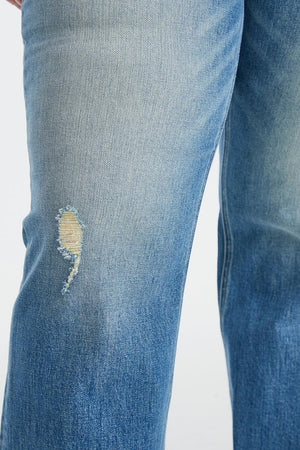 a person wearing a pair of ripped jeans