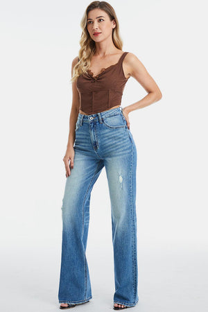 a woman wearing a brown top and jeans