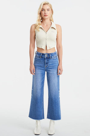 a woman wearing a crop top and jeans