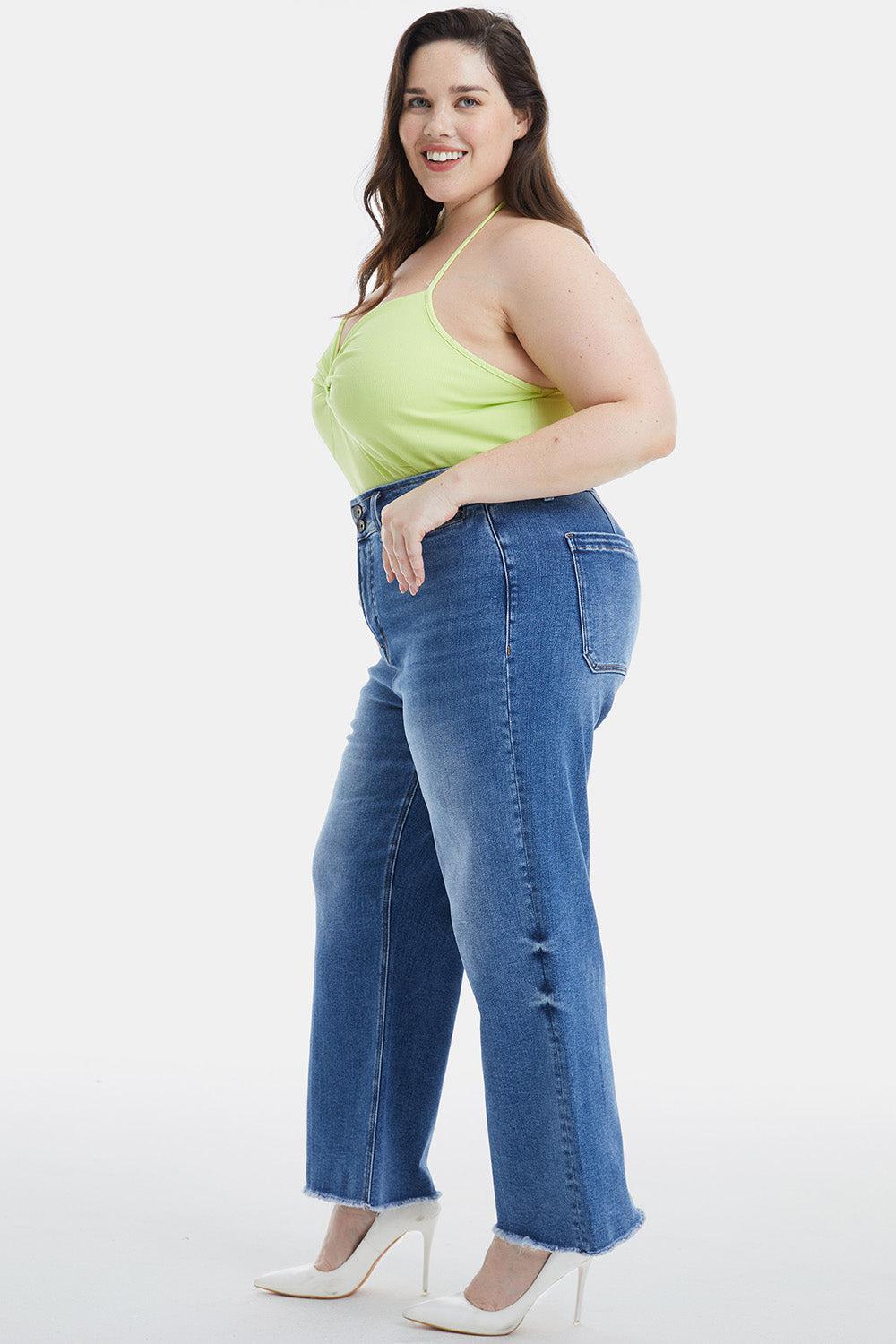 a woman in a yellow tank top and jeans