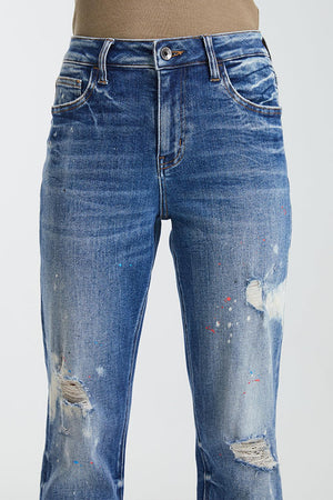 a pair of jeans that have been ripped and have some paint splatters on