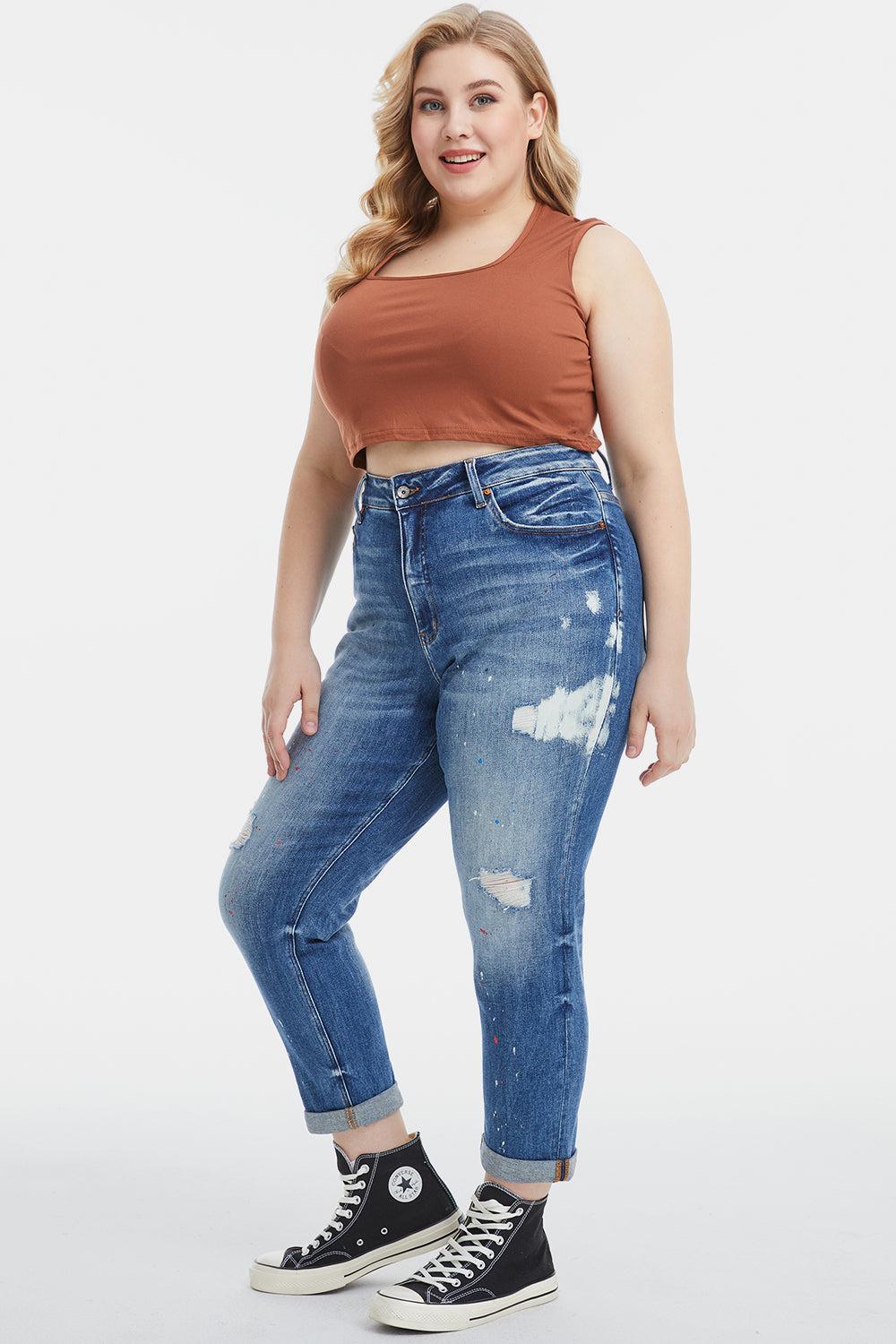a woman in a brown tank top and ripped jeans