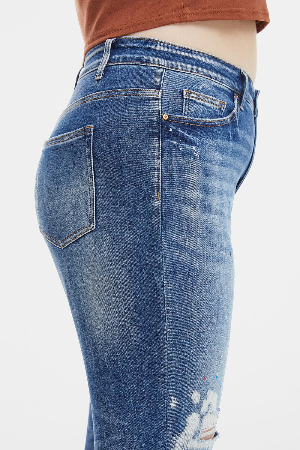 a woman's butt showing her ripped jeans