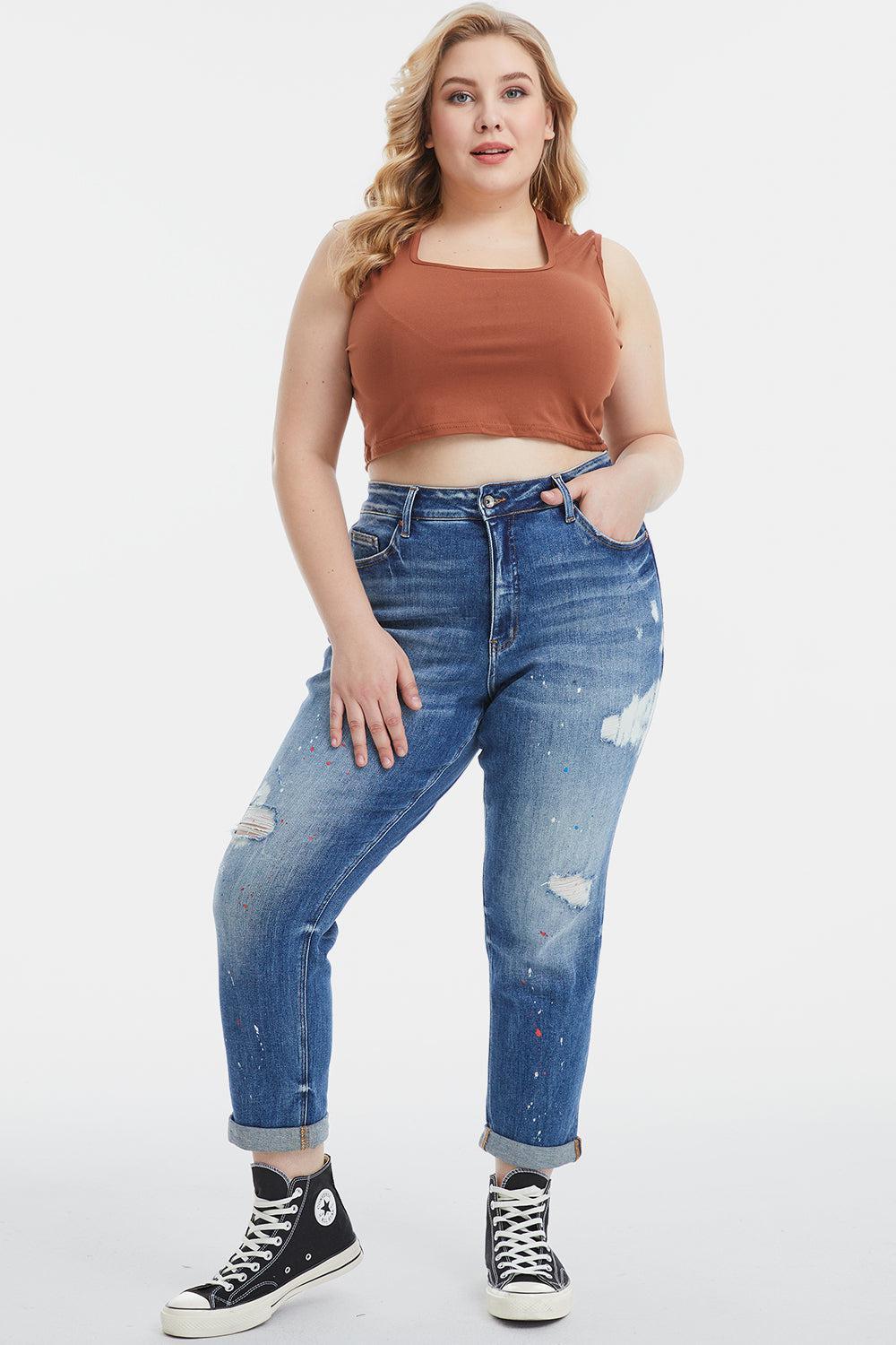 a woman in a crop top and ripped jeans