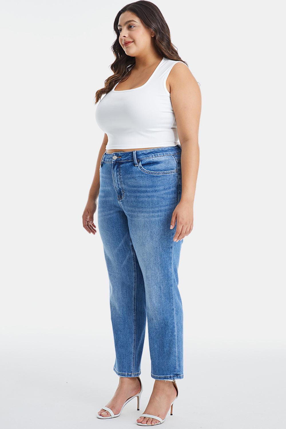 a woman in a white tank top and jeans