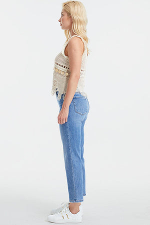 a woman in jeans and a tank top