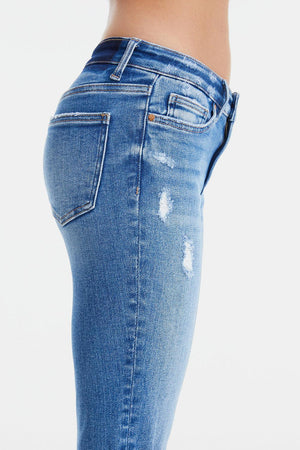 a woman's butt showing her ripped jeans