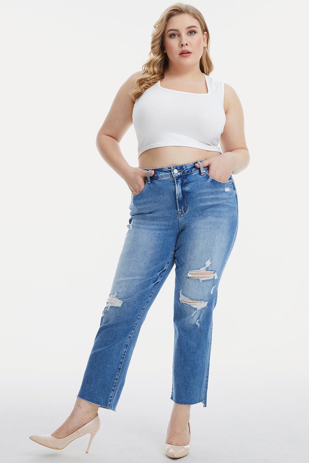 a woman in a white crop top and ripped jeans
