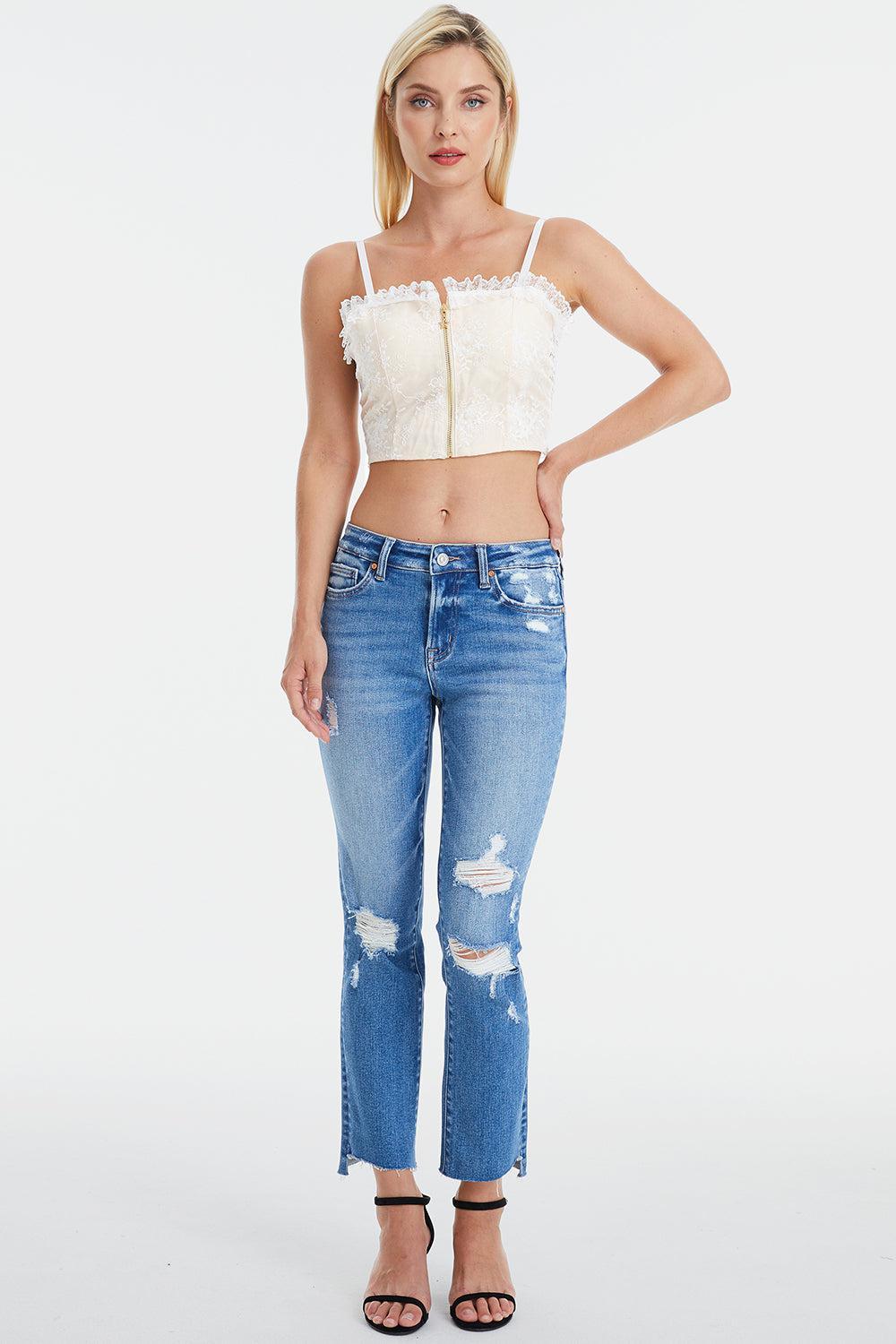 a woman in ripped jeans and a crop top