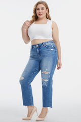 a woman in a white top and ripped jeans