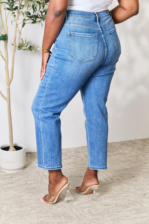 a woman wearing high rise jeans and heels