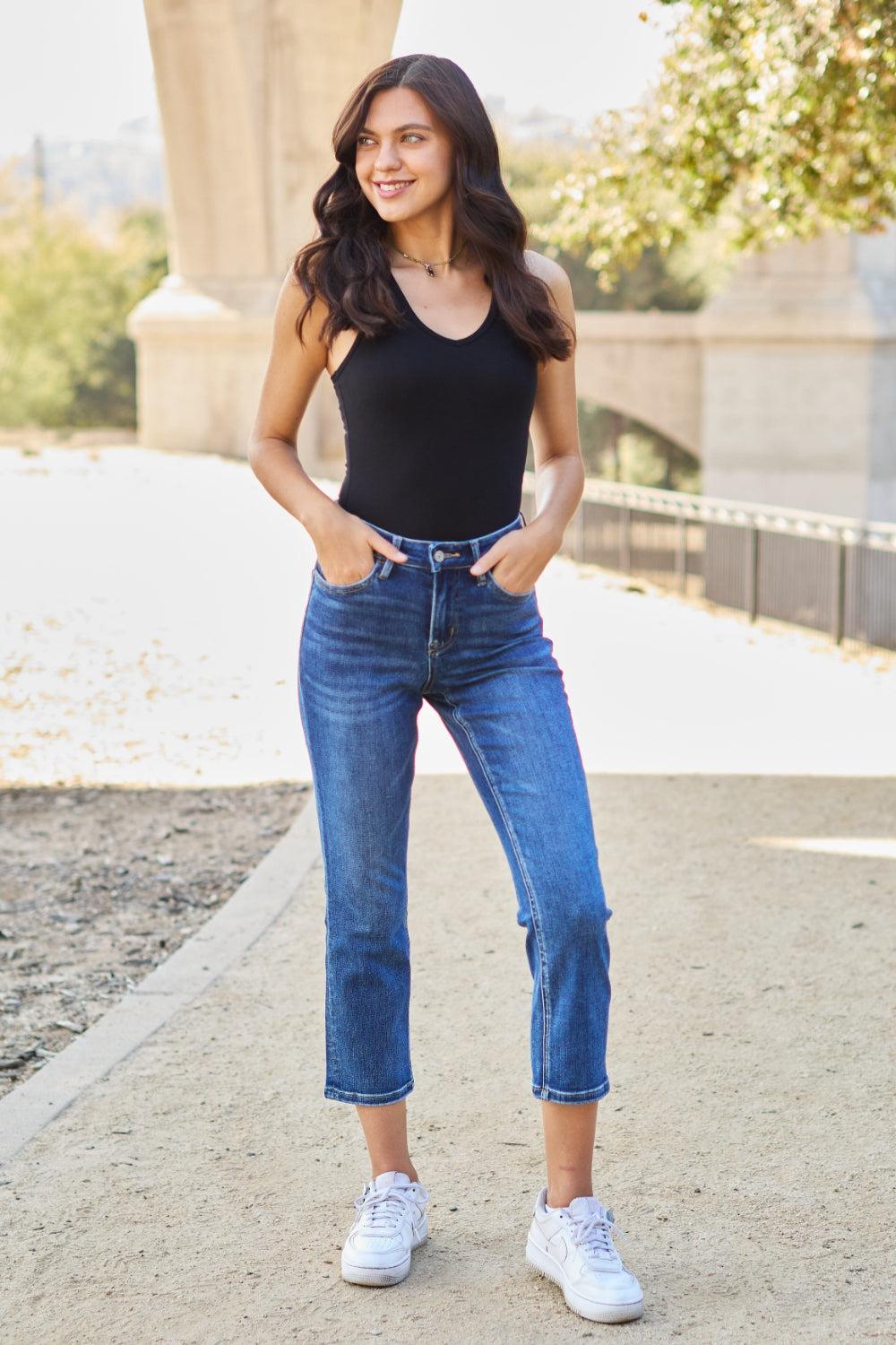 a woman in black shirt and jeans posing for a picture