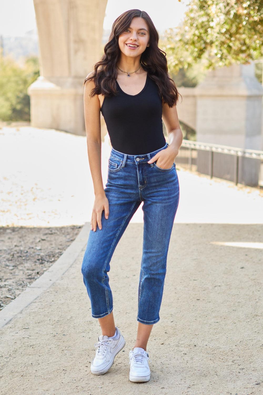 a woman in black shirt and jeans posing for a picture