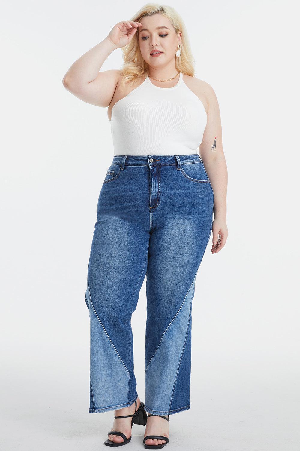 a woman in a white tank top and blue jeans