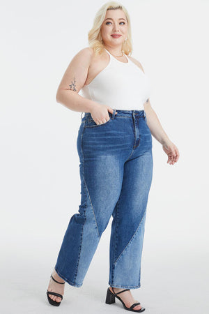 a woman in a white tank top and blue jeans