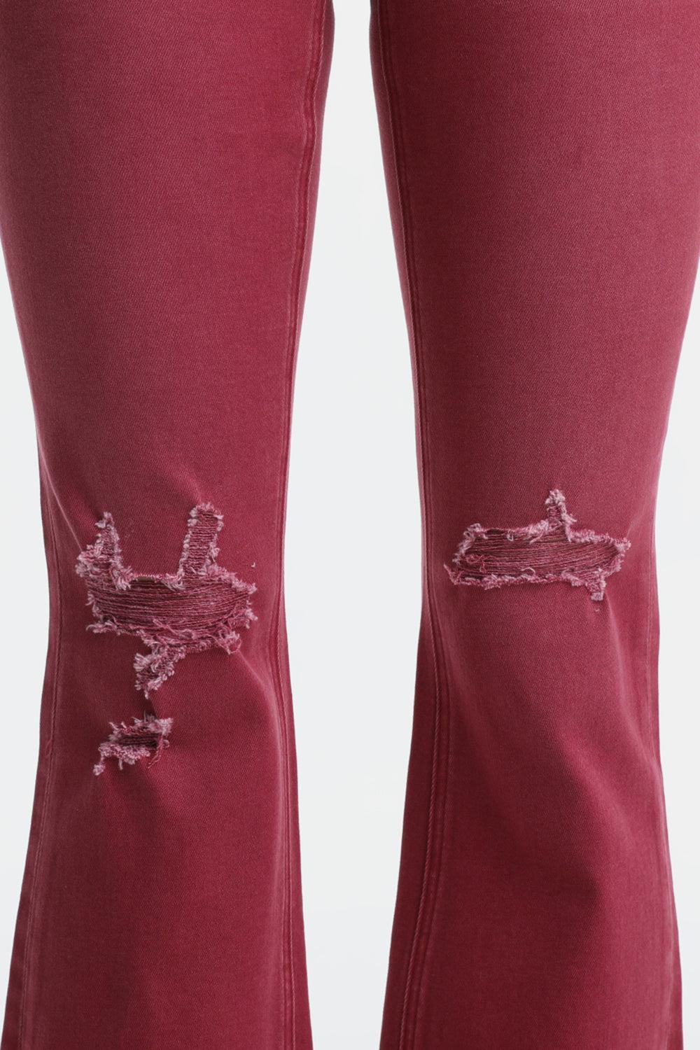 a pair of red jeans with a boat drawn on them