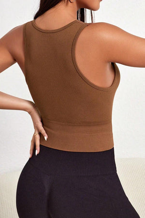 a woman wearing a brown top and black leggings