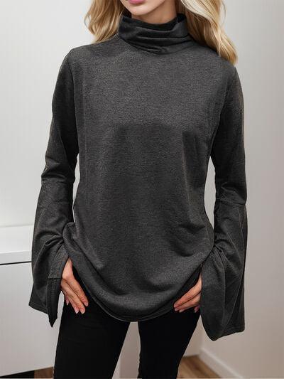 a woman wearing a black turtle neck sweater