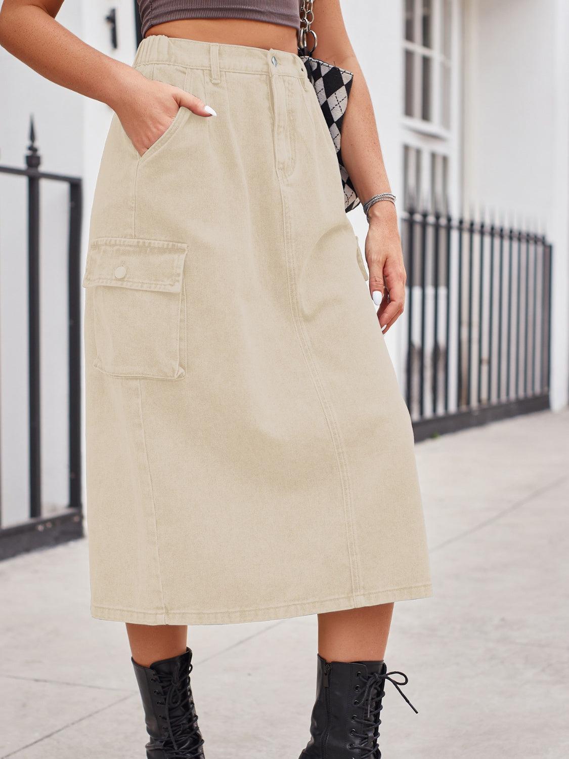 a woman wearing a tan skirt and black boots