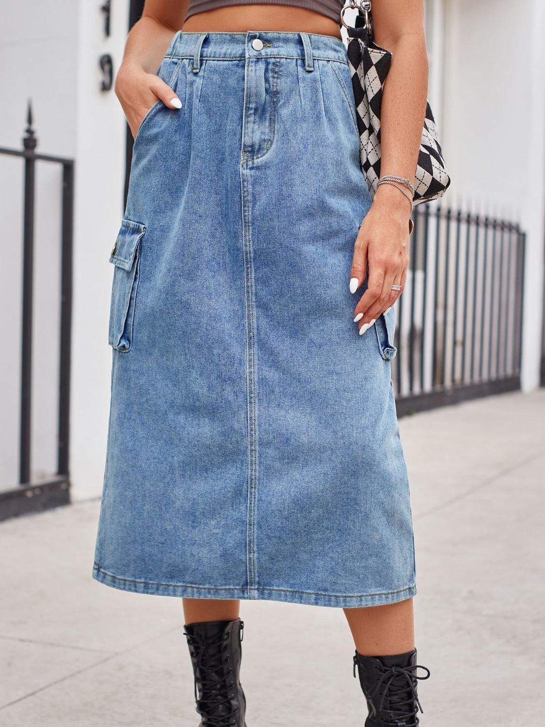 a woman wearing a denim skirt and black boots