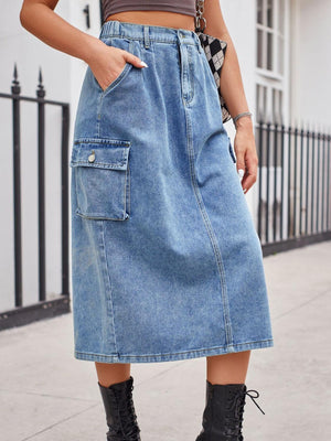 a woman wearing a denim skirt and black boots