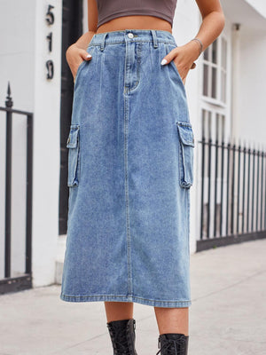 a woman wearing a denim skirt and black boots