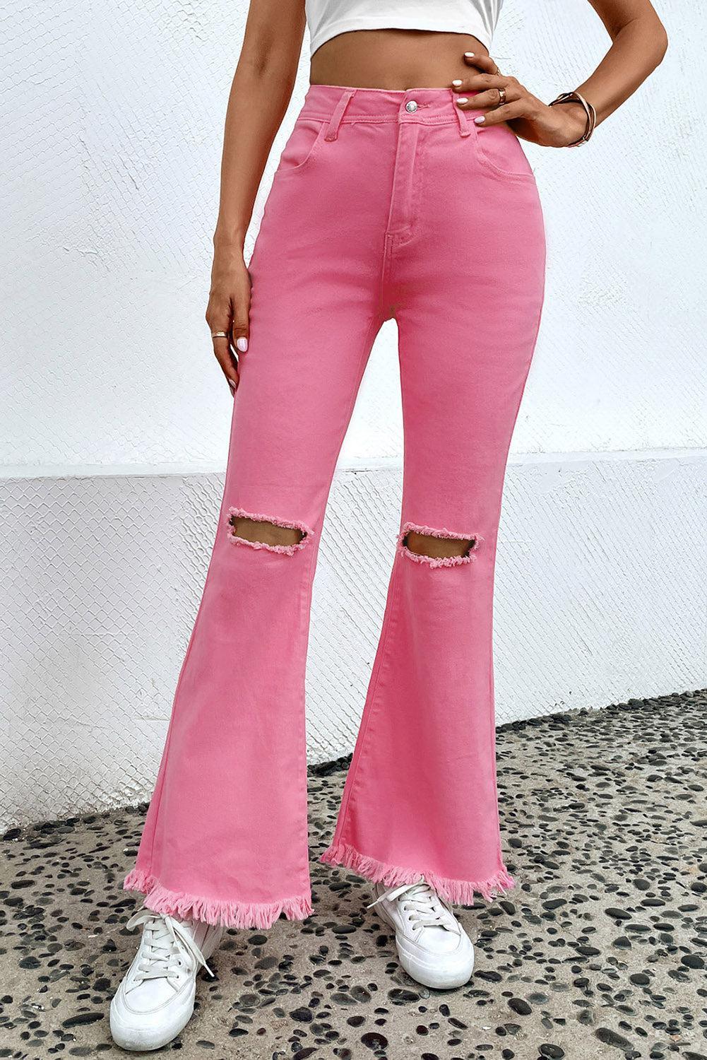 a woman in a white top and pink jeans