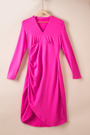 a bright pink dress hanging on a hanger