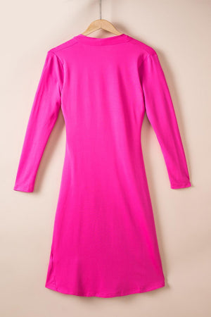 a bright pink dress hanging on a hanger