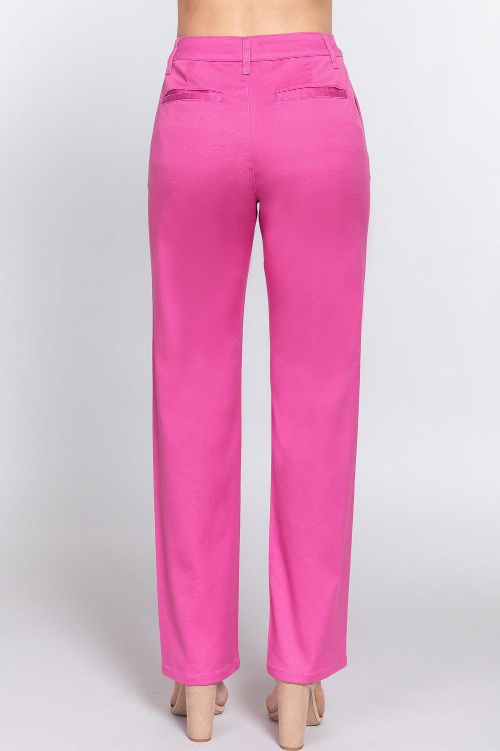 a woman wearing pink pants and heels