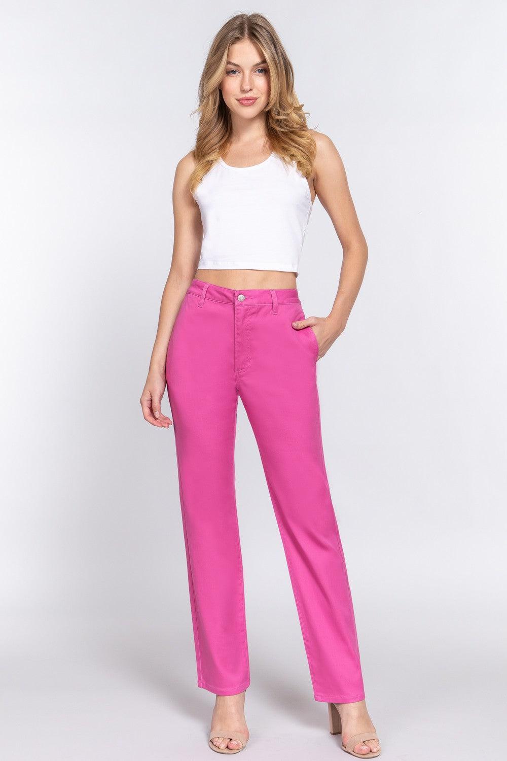 a woman in a white top and pink pants