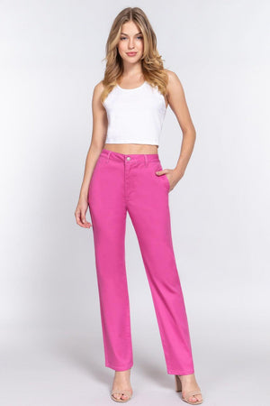 a woman in a white top and pink pants