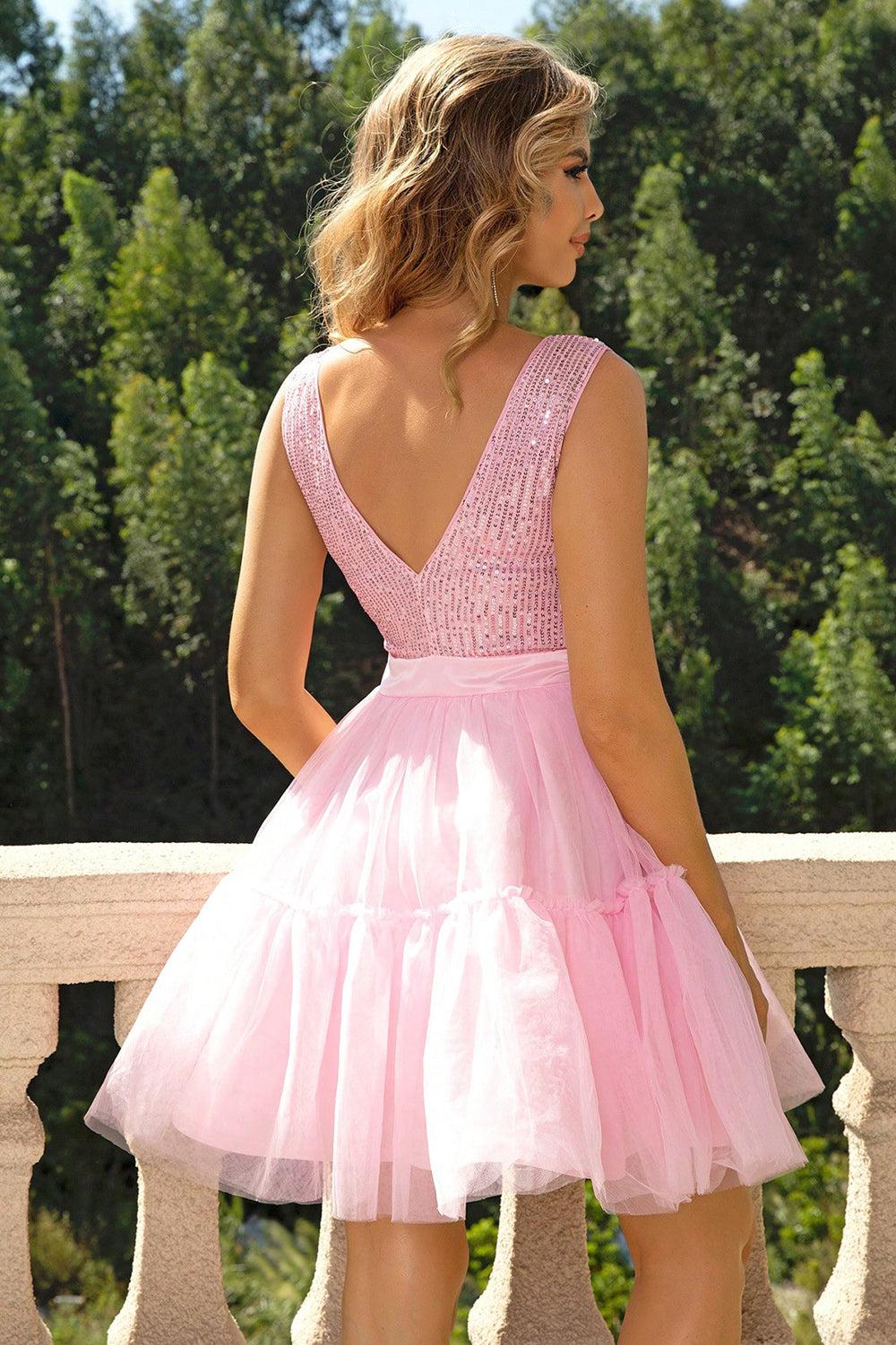 a woman in a pink dress standing on a balcony