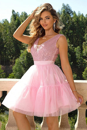 a woman in a pink dress posing for a picture