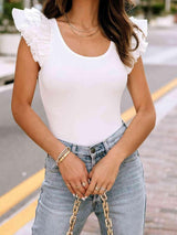 a woman wearing a white top and jeans