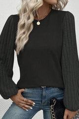 a woman wearing a black top and jeans