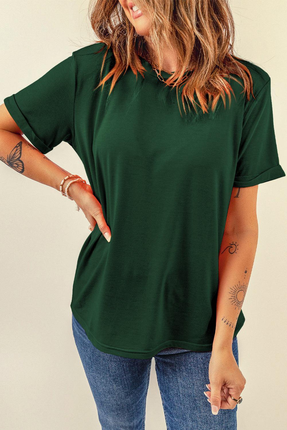 a woman wearing a green shirt and jeans