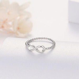 a white gold ring with an infinite sign on it