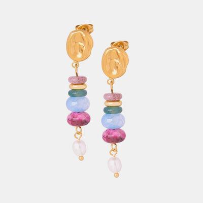 a pair of earrings with beads and a gold disc