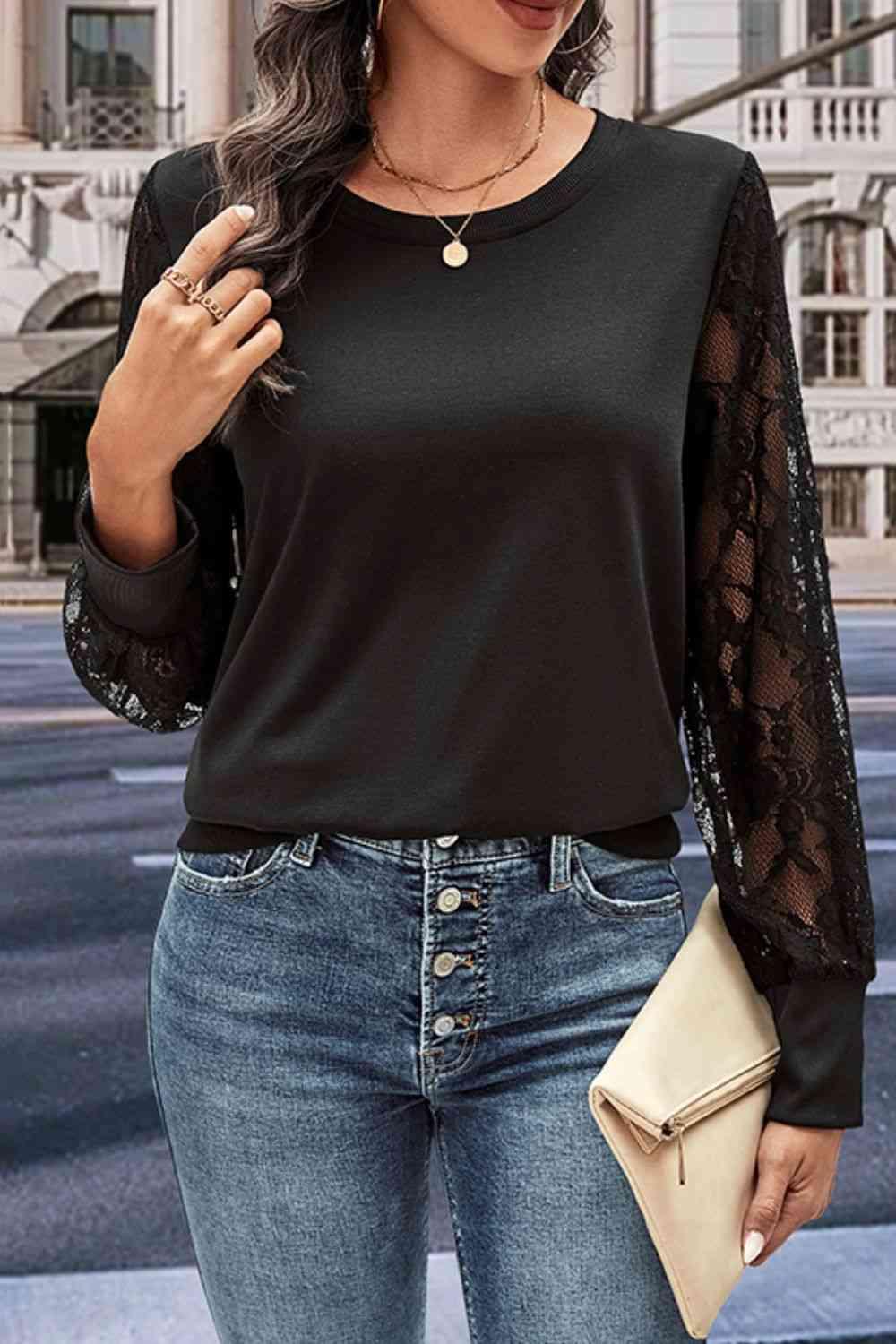 a woman wearing a black top and jeans