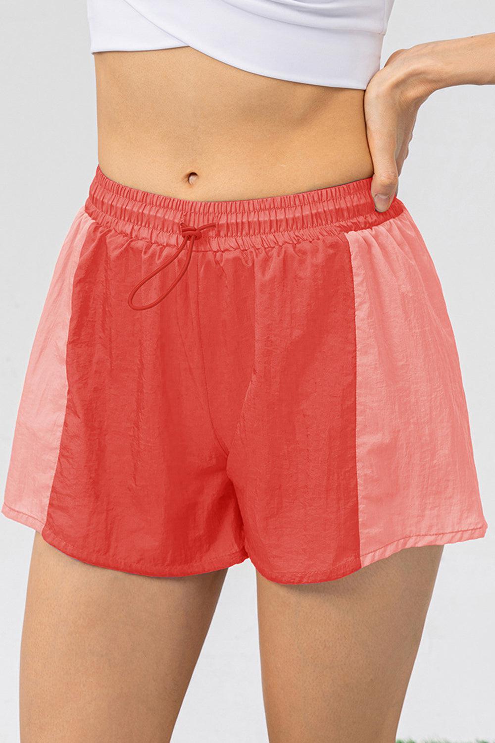 a close up of a person wearing a red shorts