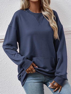 a woman wearing a blue sweatshirt and jeans