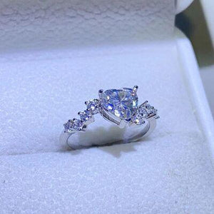a ring with a heart shaped diamond in a box