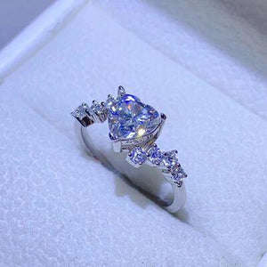 a ring with a cushion cut diamond in a box