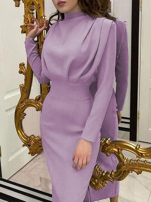 a woman in a purple dress standing in front of a mirror