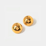 a pair of gold earrings with a face on it