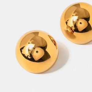 a pair of gold toned metal knobs on a white background