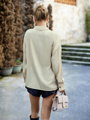 a woman walking down a street carrying a pink purse