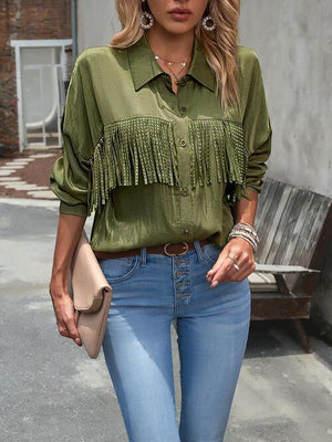 a woman wearing a green shirt and jeans